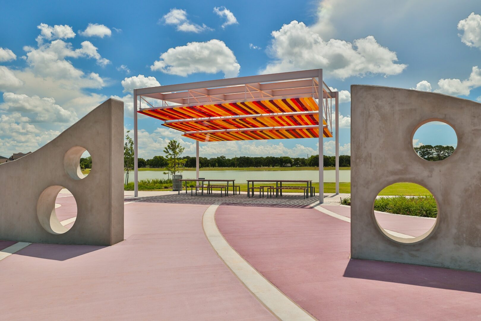Custom pavilion with sculptural concrete portals at Candela Sunshine Park