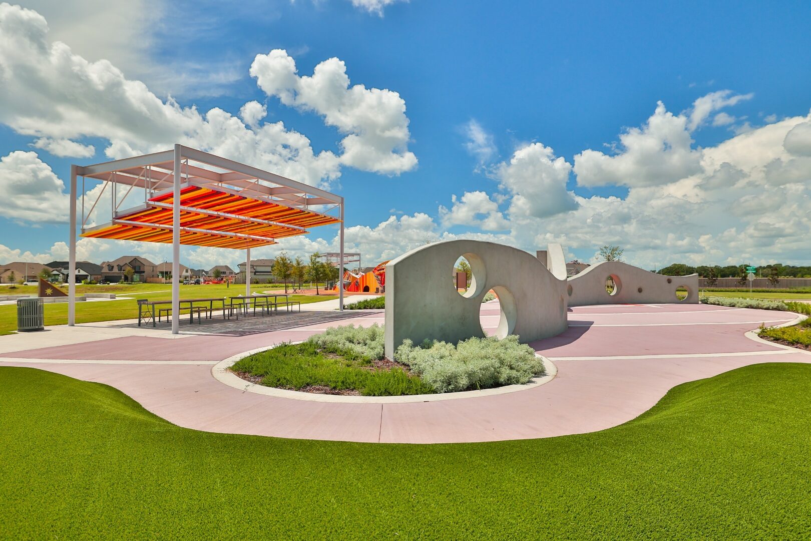 Candela Sunshine Park pavilion with sunrise-colored louvers over a lake