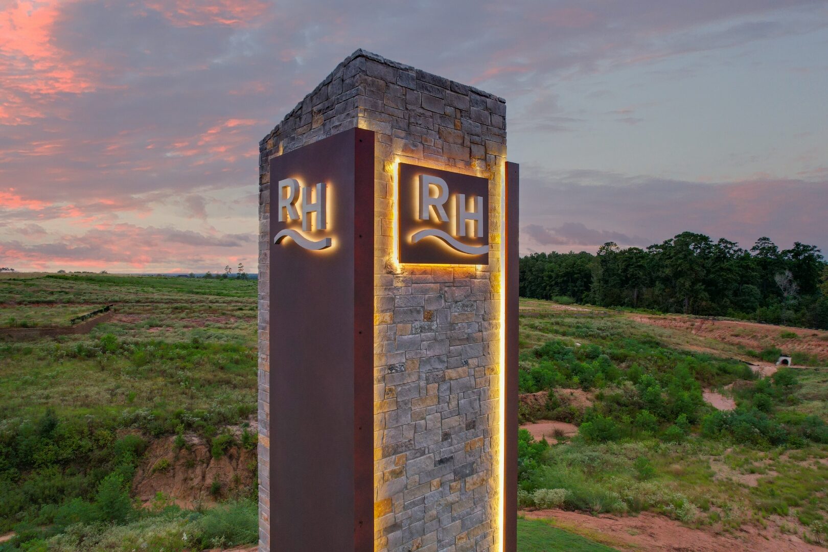 Ridgeland Hills stone and Corten steel monument tower, illuminated at dusk