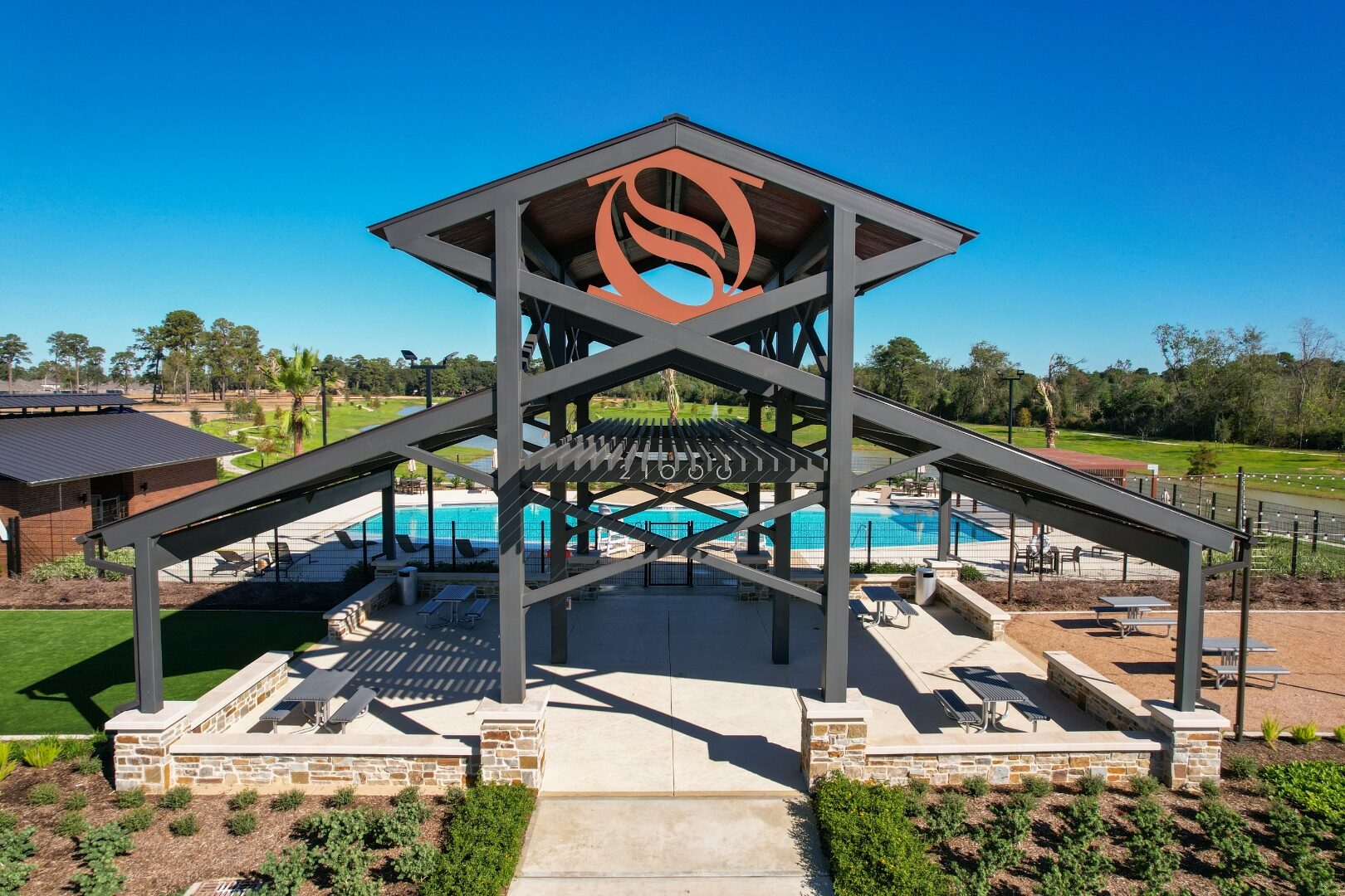 Sorella Amenity Center tower pavilion with coral cut-metal S emblem