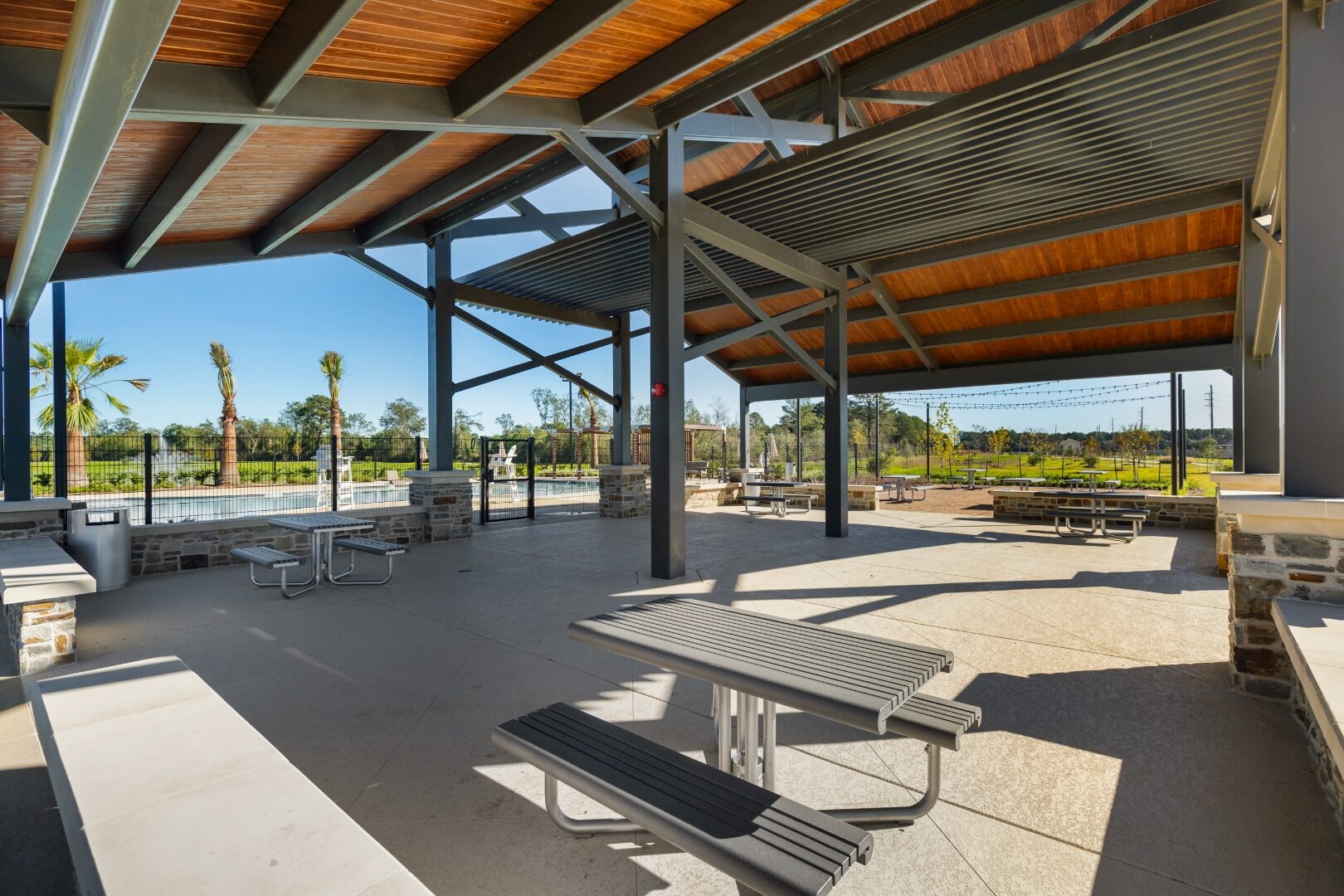 Interior view under the Sorella pavilion with stained wood ceiling and steel beams